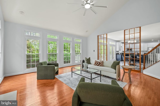 13017 English Turn Dr, Silver Spring, MD 20904 - living room featuring stairway, high vaulted ceiling, ceiling fan with notable chandelier, and wood finished floors
