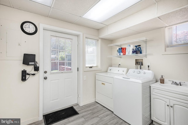 5511 Gwyn Pl, Alexandria, VA 22312 - laundry area with separate washer and dryer, cabinet space, baseboards, and light wood-style floors