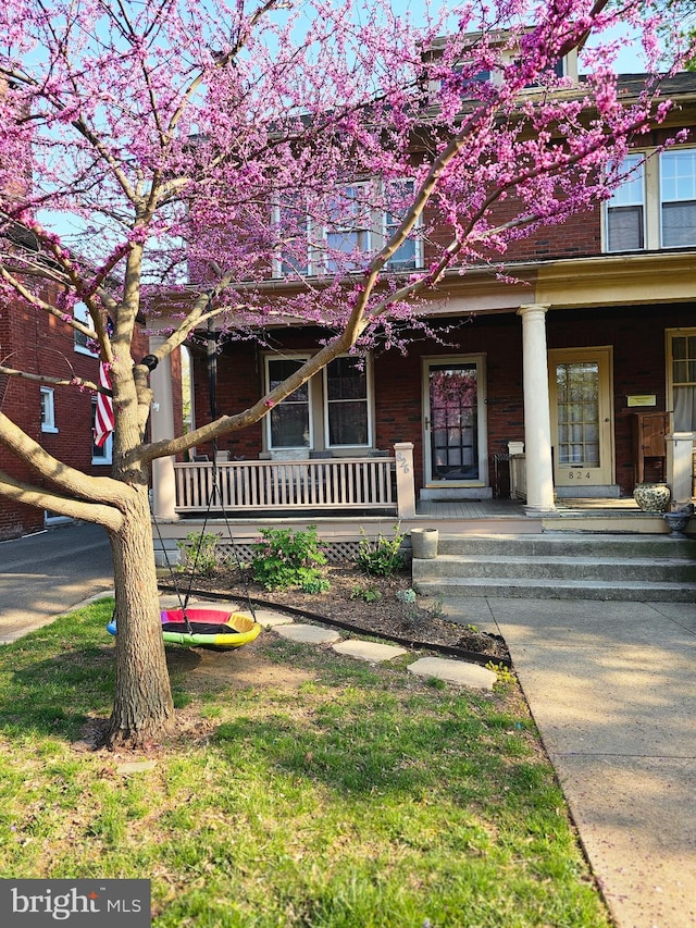 view of front of property with brick siding and a porch