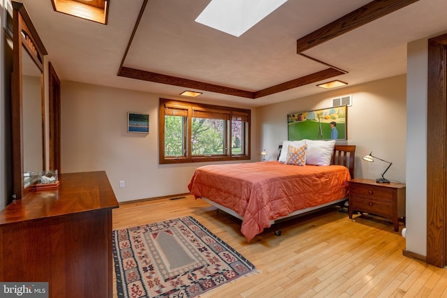 715 W Park Ave, State College, PA 16803 - bedroom with light wood finished floors, a skylight, a tray ceiling, and visible vents