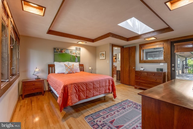 715 W Park Ave, State College, PA 16803 - bedroom featuring a skylight, light wood-style flooring, and a tray ceiling