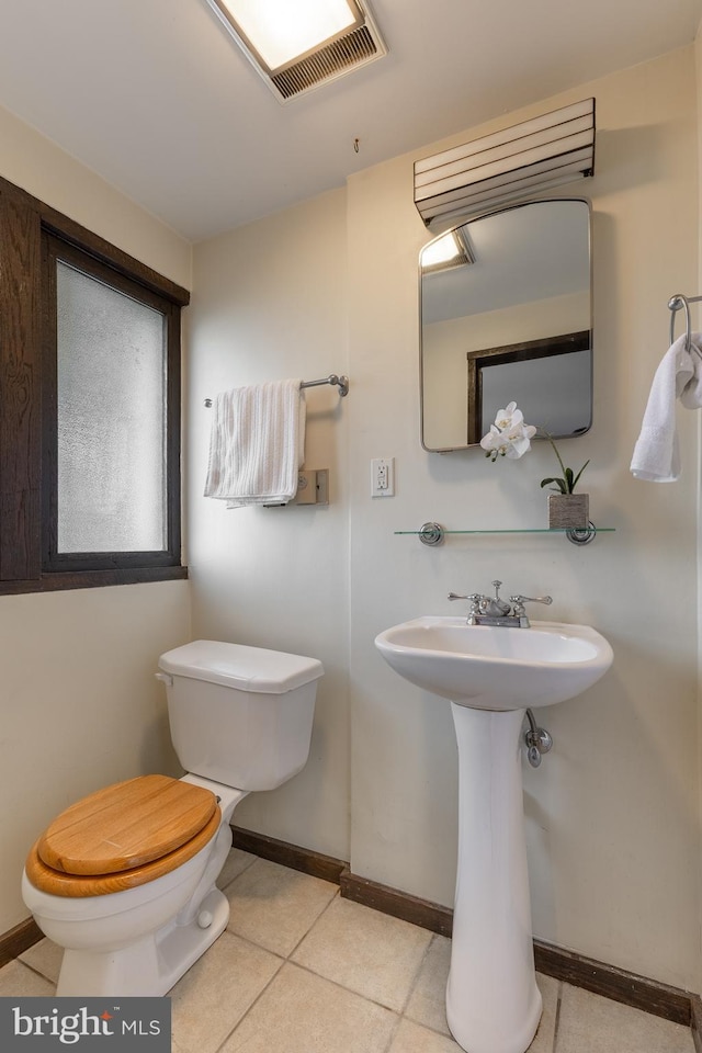 715 W Park Ave, State College, PA 16803 - half bathroom featuring tile patterned flooring, toilet, baseboards, and a sink