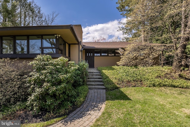 715 W Park Ave, State College, PA 16803 - view of front of property featuring a shingled roof, a front lawn, and stucco siding