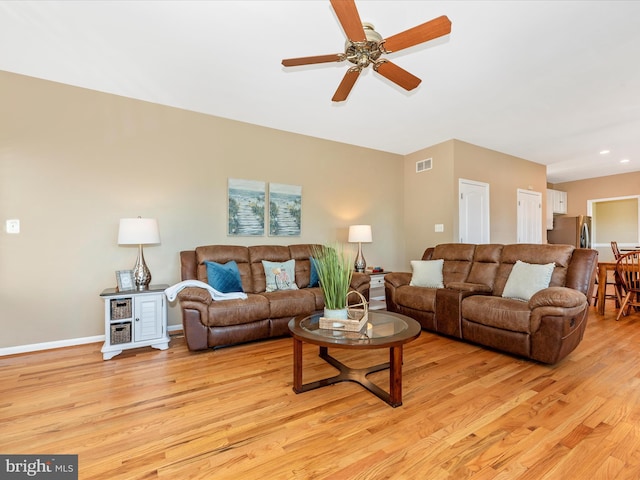 living room featuring ceiling fan, visible vents, baseboards, light wood finished floors, and recessed lighting