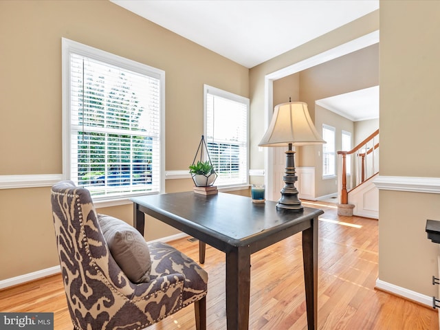 office area featuring baseboards and light wood-type flooring