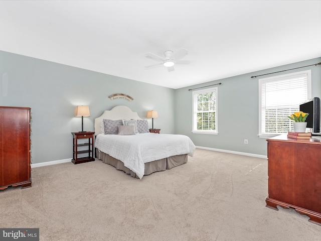 carpeted bedroom with a ceiling fan and baseboards