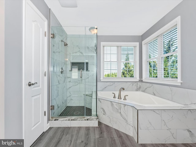 bathroom with a marble finish shower and a bath