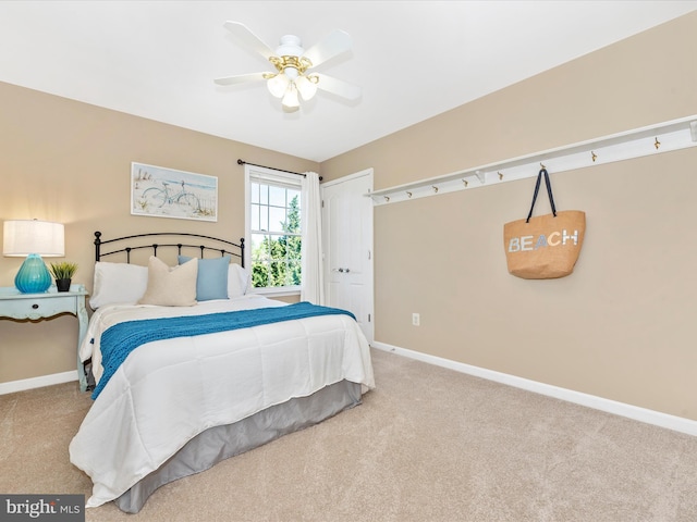 carpeted bedroom with baseboards and ceiling fan