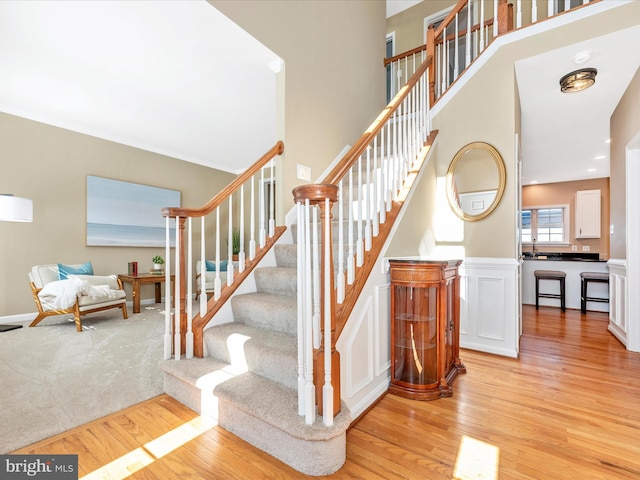 stairs featuring wood finished floors