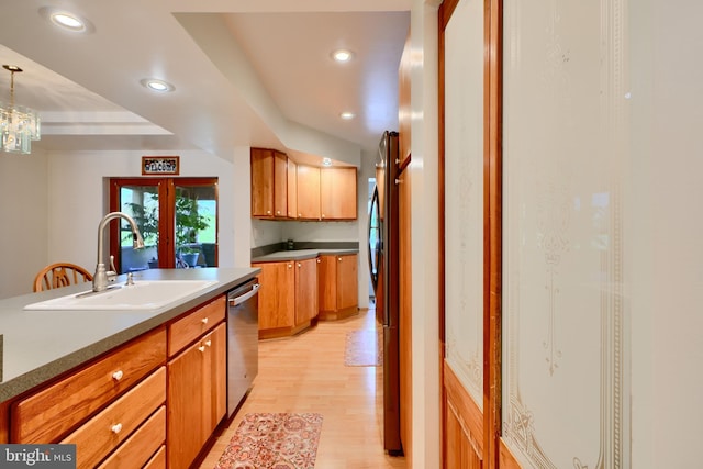 kitchen with brown cabinetry, stainless steel dishwasher, a sink, light wood finished floors, and recessed lighting