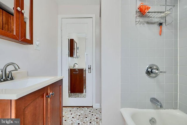 full bath featuring tile patterned floors, shower / bathing tub combination, and vanity