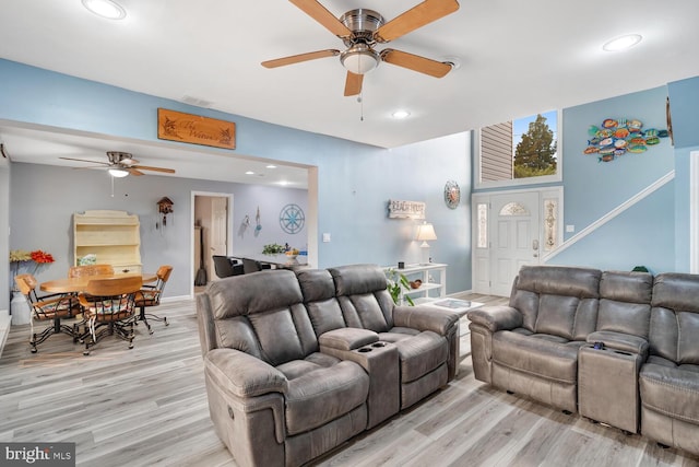 living room featuring light wood-style floors, a ceiling fan, visible vents, and recessed lighting