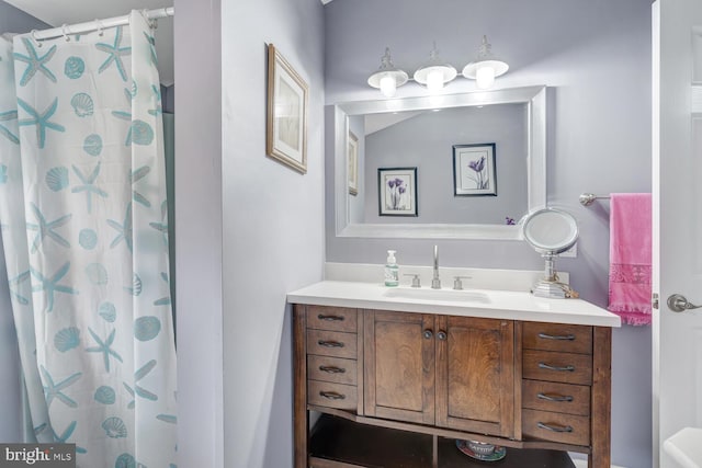 bathroom with curtained shower and vanity