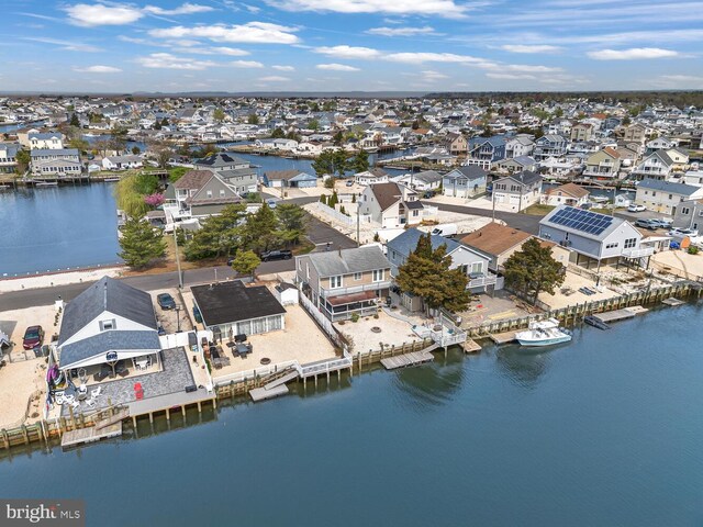 drone / aerial view featuring a residential view and a water view
