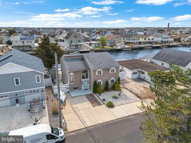 birds eye view of property with a residential view and a water view
