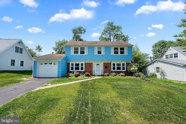 view of front of home with an attached garage, brick siding, a front lawn, and aphalt driveway