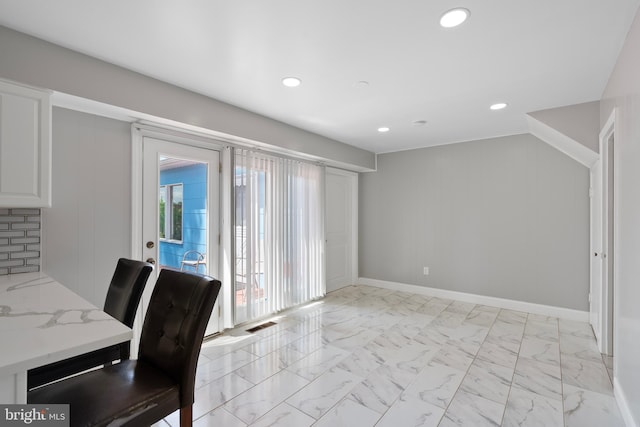 unfurnished dining area featuring baseboards, marble finish floor, visible vents, and recessed lighting