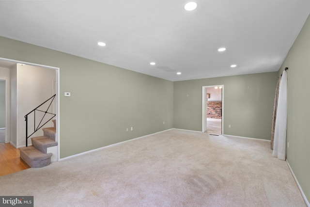 spare room featuring stairway, baseboards, carpet floors, and recessed lighting