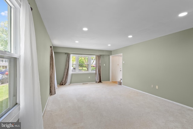 empty room featuring baseboards, recessed lighting, and carpet