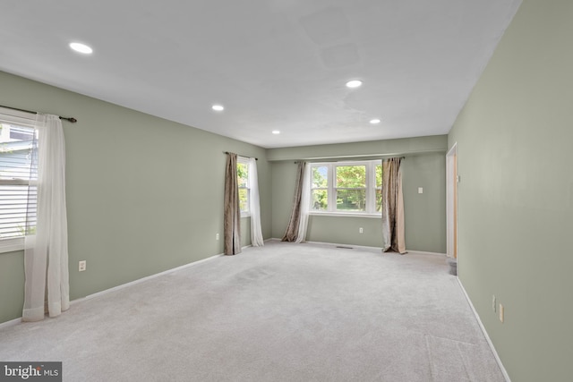 empty room featuring carpet floors, baseboards, and recessed lighting
