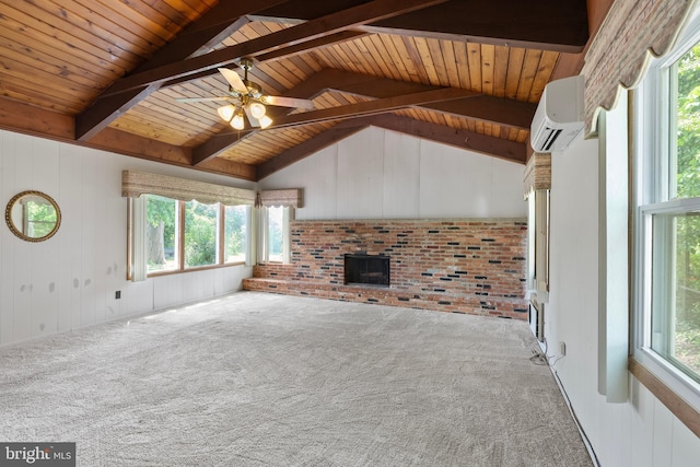 unfurnished living room with a fireplace, a wall mounted air conditioner, carpet, and plenty of natural light