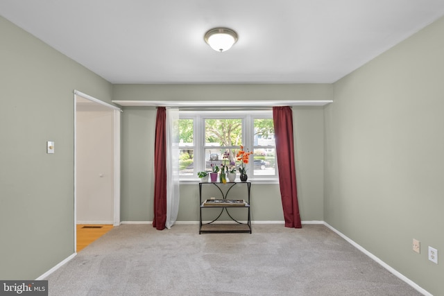spare room with carpet floors and baseboards