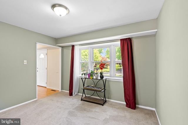 carpeted empty room with baseboards