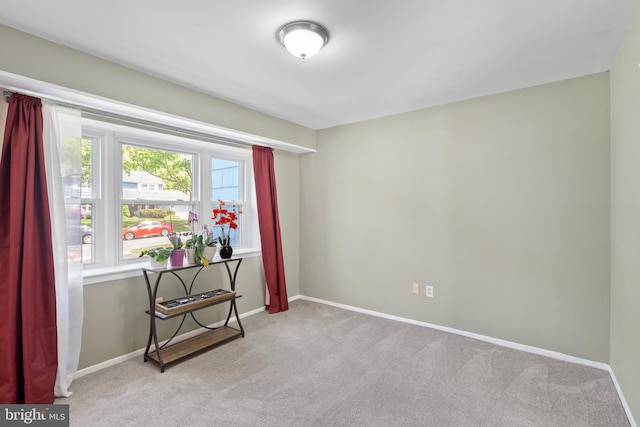unfurnished room featuring baseboards and carpet
