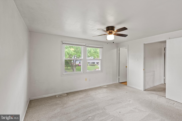 unfurnished bedroom with carpet flooring, baseboards, a ceiling fan, and visible vents