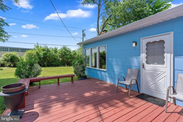 wooden deck with a lawn