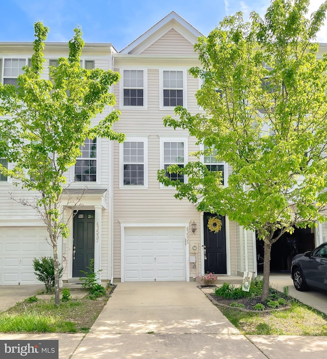 townhome / multi-family property with concrete driveway and an attached garage