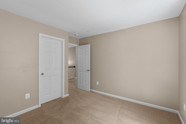 unfurnished bedroom with carpet floors and baseboards