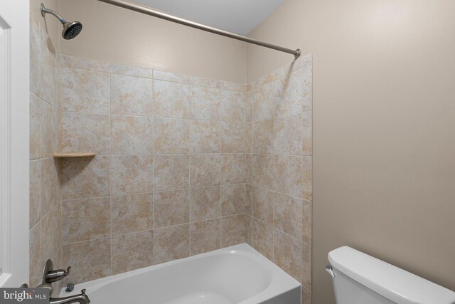 bathroom with tub / shower combination and toilet