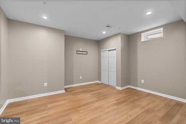 interior space featuring recessed lighting, light wood-type flooring, visible vents, and baseboards