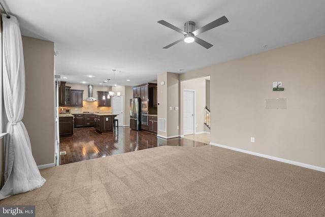 living area featuring recessed lighting, dark carpet, a ceiling fan, and baseboards