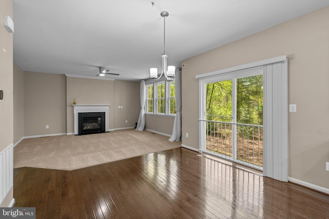 unfurnished living room featuring a fireplace with flush hearth, baseboards, a ceiling fan, and hardwood / wood-style floors