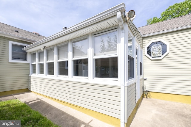 view of home's exterior with a shingled roof