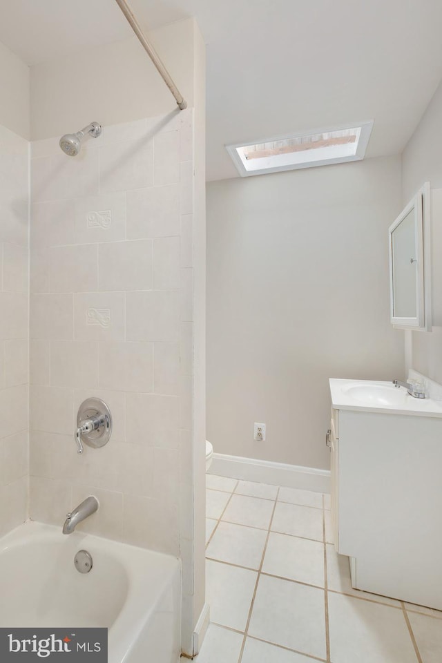 full bathroom with vanity, tile patterned flooring, baseboards, a skylight, and shower / washtub combination