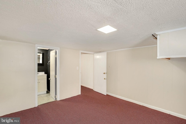 finished basement with carpet flooring and a textured ceiling