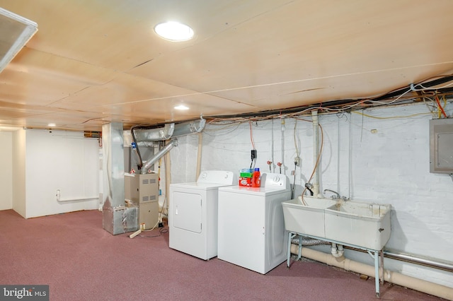 laundry room with electric panel, a sink, heating unit, carpet, and washer and dryer