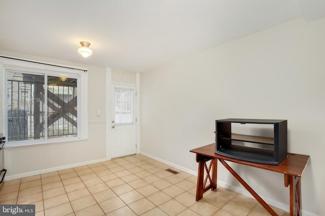foyer entrance featuring baseboards and visible vents