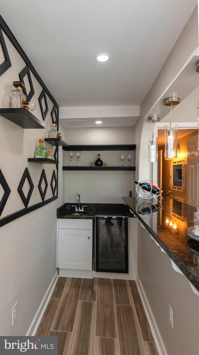 kitchen featuring wood finish floors, white cabinetry, open shelves, and wine cooler