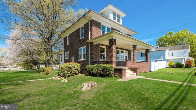 147 S Main St, Dublin, PA 18917 - american foursquare style home featuring brick siding, a porch, and a front yard