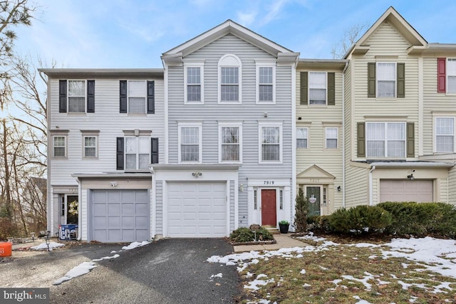 multi unit property featuring driveway and a garage