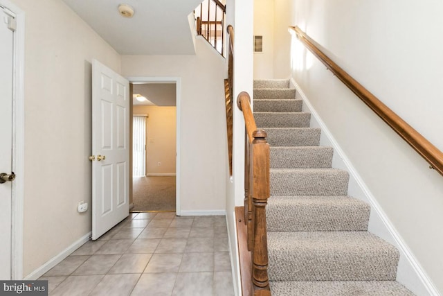 staircase featuring baseboards, tile patterned flooring, and visible vents