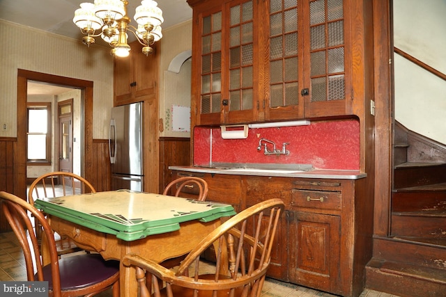 interior space with wooden walls, a wainscoted wall, and a chandelier