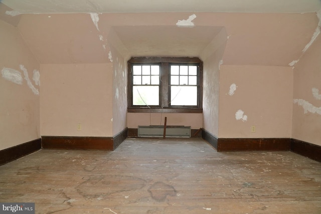 bonus room with baseboards, hardwood / wood-style flooring, and lofted ceiling