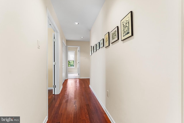 hall with dark wood-style floors, recessed lighting, and baseboards