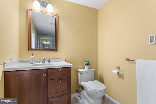 bathroom featuring vanity, toilet, visible vents, baseboards, and tile patterned flooring