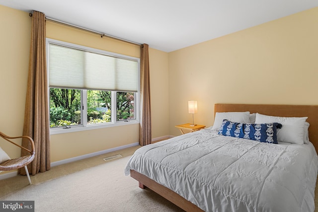 carpeted bedroom with visible vents and baseboards